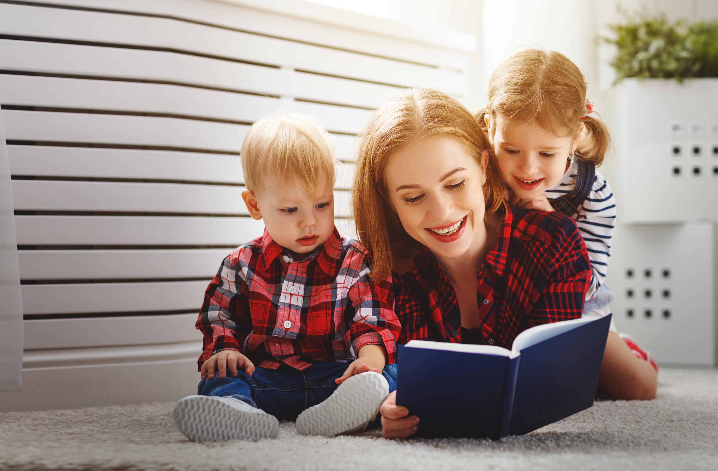 Mother reads book to children